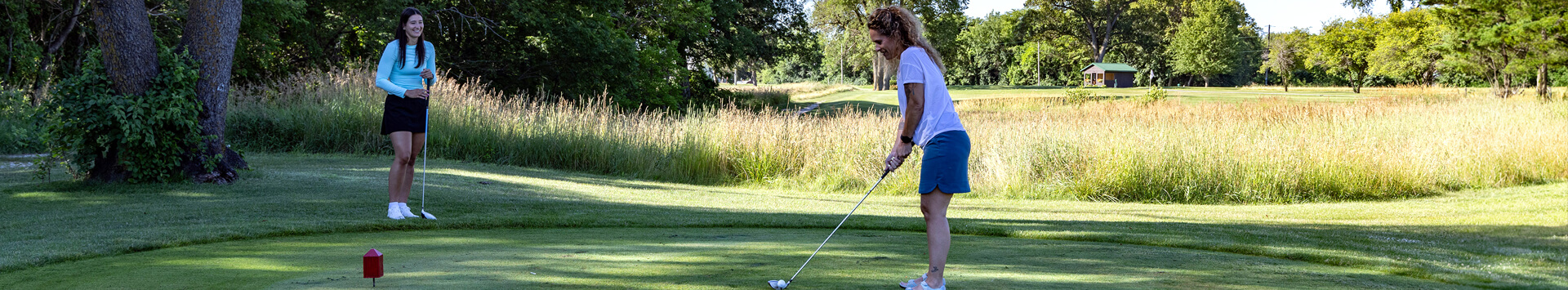 Woman about to tee off at Indian Bluff Golf Course