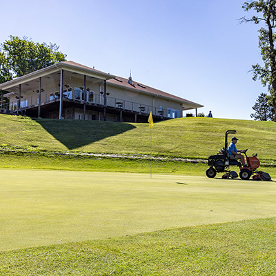 Staff mowing the course