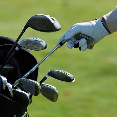 Golfer pulling a club out of his bag