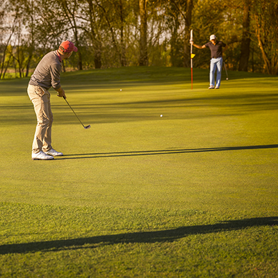 Golfer putting the ball
